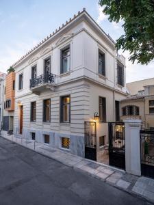 a white building on the side of a street at The White House in Plaka by JJ Hospitality in Athens