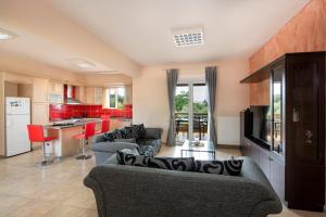 a large living room with couches and a kitchen at Valia's House in Kato Daratso +35 photos