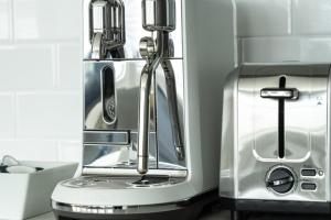 a kitchen with a toaster and a coffee maker at Station Inn Pawling in Pawling