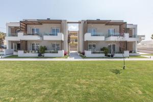 a large apartment building with a green yard at Val Del Mar in Skala Fourkas