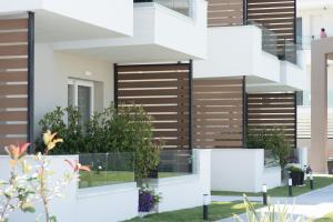 a facade of a house with wooden shutters at Val Del Mar in Skala Fourkas