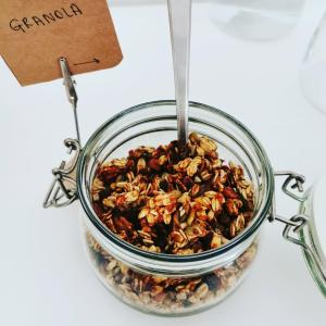 a glass jar of granola with a sign in it at Sentiero Verde B&B in Formazza