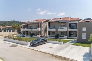 a car parked in a parking lot in front of houses at Val Del Mar in Skala Fourkas