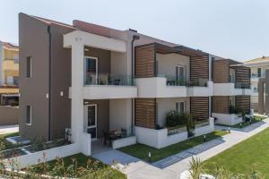 an apartment building with wooden shutters on the balconies at Val Del Mar in Skala Fourkas