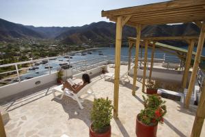 a woman sitting in a chair on the deck of a boat at Hotel Bahia Taganga in Taganga