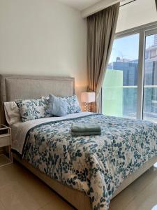 a bedroom with a bed with a large window at Athesa Apartments Downtown Dubai Business Bay in Dubai