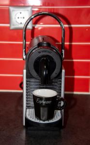 a coffee maker with a cup on a counter at Valia's House in Kato Daratso