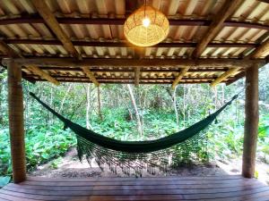 a hammock in a pergola in a forest at Vila Floresta - Chalé da Mata in Sao Jorge