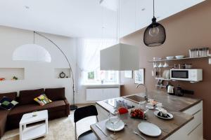 a kitchen and living room with a couch and a table at New stylish studio in the center in Rīga