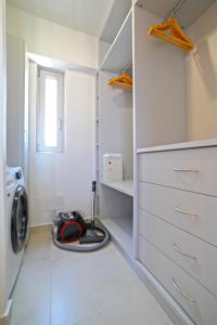 a white laundry room with a washing machine in it at Heraklion Harbour Penthouse in Heraklio Town