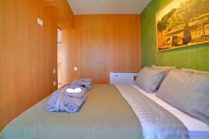 a bedroom with a bed with a towel on it at Heraklion Harbour Penthouse in Heraklio Town +46 photos