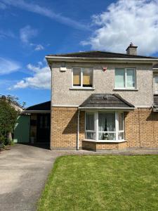 a brick house with a dog in the window at Adaline House Dublin in Dublin