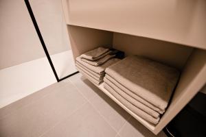 a small closet with folded towels in it at Sodoben apartma v centru Ljubljane in Ljubljana +20 photos