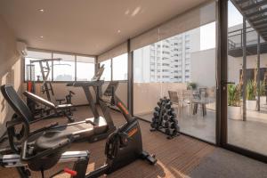 a gym with treadmills and ellipticals in a building at Like Design Hotel Rivera in Rivera