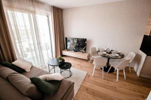 a living room with a couch and a table at Sodoben apartma v centru Ljubljane in Ljubljana