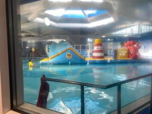 an indoor water park with a water slide at The Woodlark Lodge at Rockley Park in Lytchett Minster