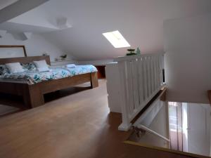 a bedroom with a bed and a staircase in it at Apartment ANGELOVE in Senj