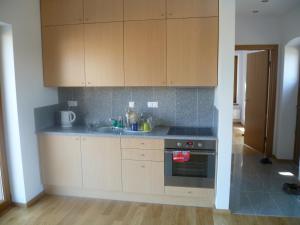 a kitchen with wooden cabinets and a sink at Lake House in Kościan +10 photos