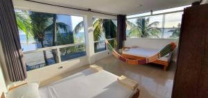 a room with a hammock and a view of the ocean at Casa Maya Playa El Yaque in El Yaque