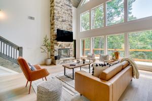 a living room with a couch and a fireplace at Luxe Sevierville Home with Deck Near Pigeon Forge! in Sevierville