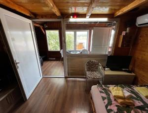 a room with a bed and a laptop on a table at Sojenica Zaton - Stilt House in Belgrade