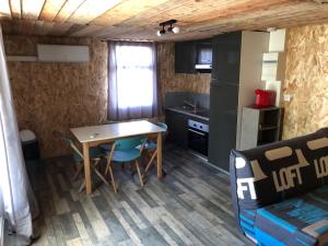 a small kitchen with a table and chairs in a room at Chalet 1 in Verrières