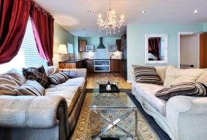 a living room with a couch and a table at Retro Seaside Apt with Patio in Swansea