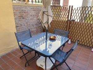 a blue table and chairs on a patio at Civico10, appartamento centrale con parcheggio e terrazzo in Piombino