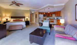 a bedroom with a bed and a living room at Honua Kai H237 in Kaanapali Airport