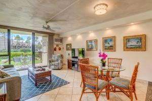 a living room with a table and chairs at Kamaole Sands 2-106 in Wailea +22 photos