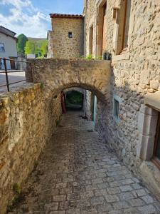 an alley in a stone building with an archway at Appartement Malleval Chez Jeanne in Malleval +7 photos