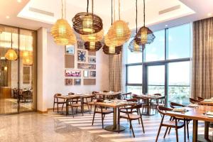 a restaurant with tables and chairs and large windows at Luxury Apartment burj khalifa view in Dubai