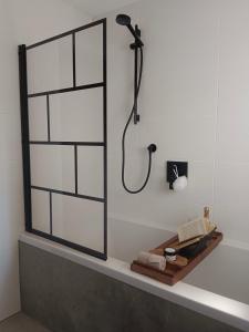 a bathroom with a shower with a black shower head at Ferienwohnungen Aumayr in Gutau