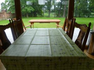 a wooden table with four chairs and a table with at Lake House in Kościan