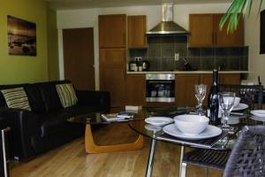 a living room with a table with plates on it at Culver House Hotel in Port-Eynon