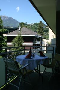 a table with a blue table cloth on a balcony at Ferienwohnung Thermen in Merano