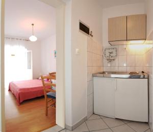 a kitchen with a sink and a room with a bed at Apartments Lanterna in Sućuraj +22 photos