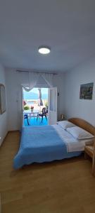 a bedroom with a bed and a view of the beach at Apartments Lanterna in Sućuraj