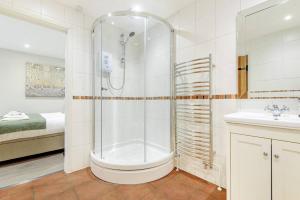 a bathroom with a shower and a toilet and a sink at The Cowshed in Farmborough +9 photos