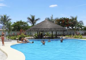 a group of people in a swimming pool at a resort at Nazca Lodge in Nazca