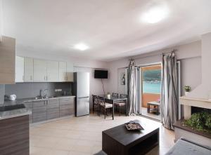 a kitchen and living room with a view of the ocean at Summer Breeze apartment in Póndi +12 photos