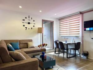 a living room with a couch and a table at Apartmani NiS in Pale