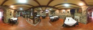 a restaurant with tables and chairs in a stone building at Casa Rural Outeiro in Outeiro