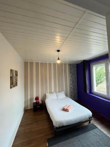 a bedroom with a white bed with a window at Appartement à Limoges in Limoges