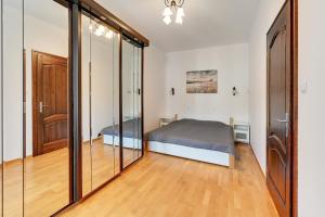 a bedroom with a bed and sliding glass doors at Dom Artysty in Sopot