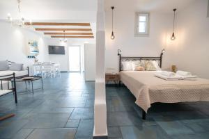 a bedroom and a living room with a bed and a table at VAGIANOU THEA celeste in Vívlos