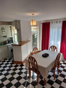 a kitchen and dining room with a table and chairs at No 3 Aughrim Holiday Village in Aughrim