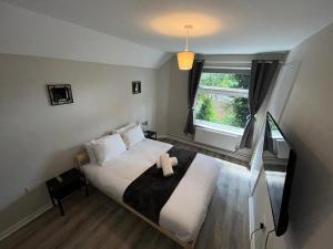 a bedroom with a large bed and a window at St Pauls Court Apartments in Stockton-on-Tees