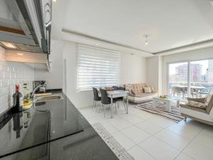 a kitchen and living room with a table and chairs at ABR 5 Residence in Alanya