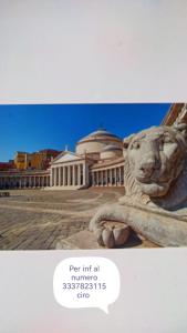 a statue of a lion in front of a building at CaSa AMELIA in Naples